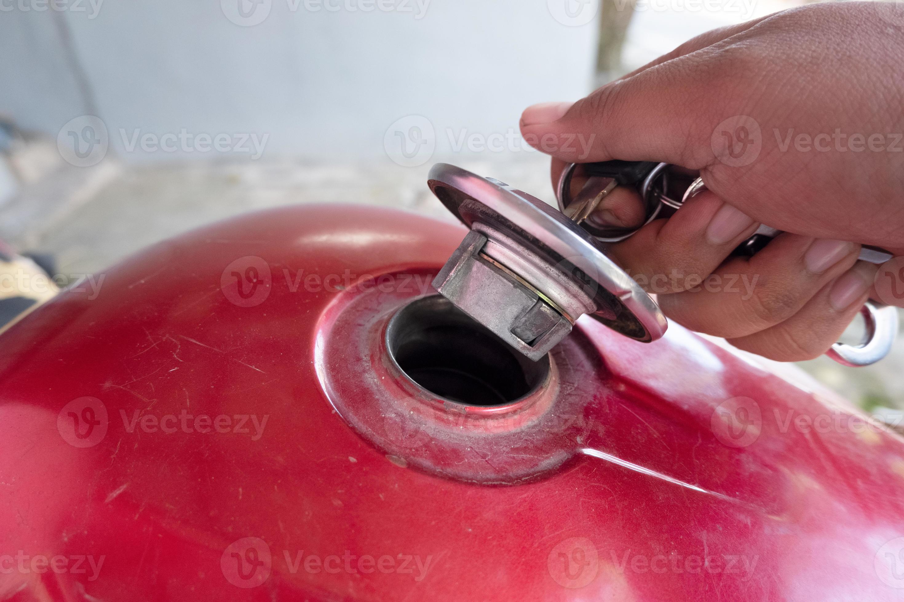 Open the motorcycle gas tank cover to refuel 15586230 Stock Photo at