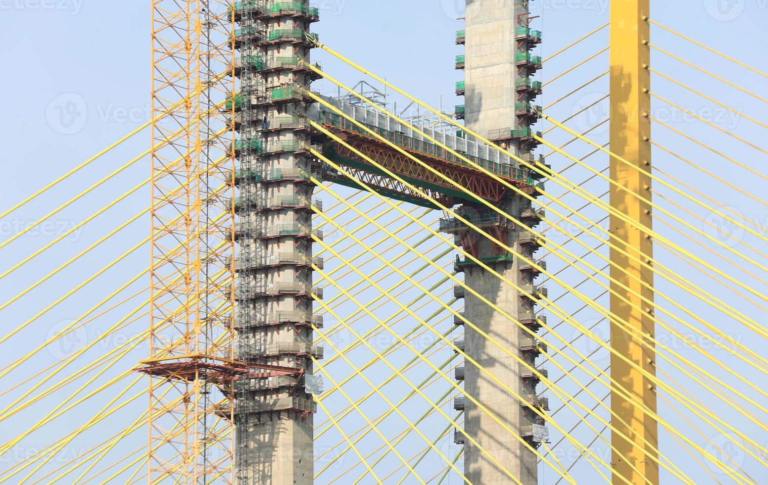 Yellow cables of under construction suspension bridge photo