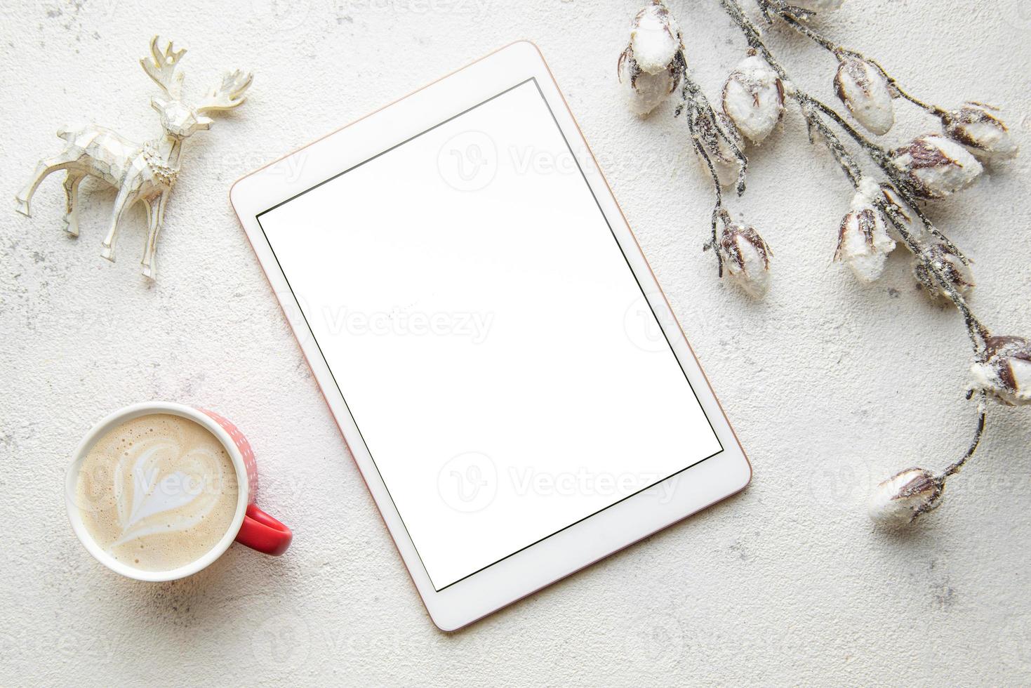 Christmas decorations and tablet on white concrete background. photo