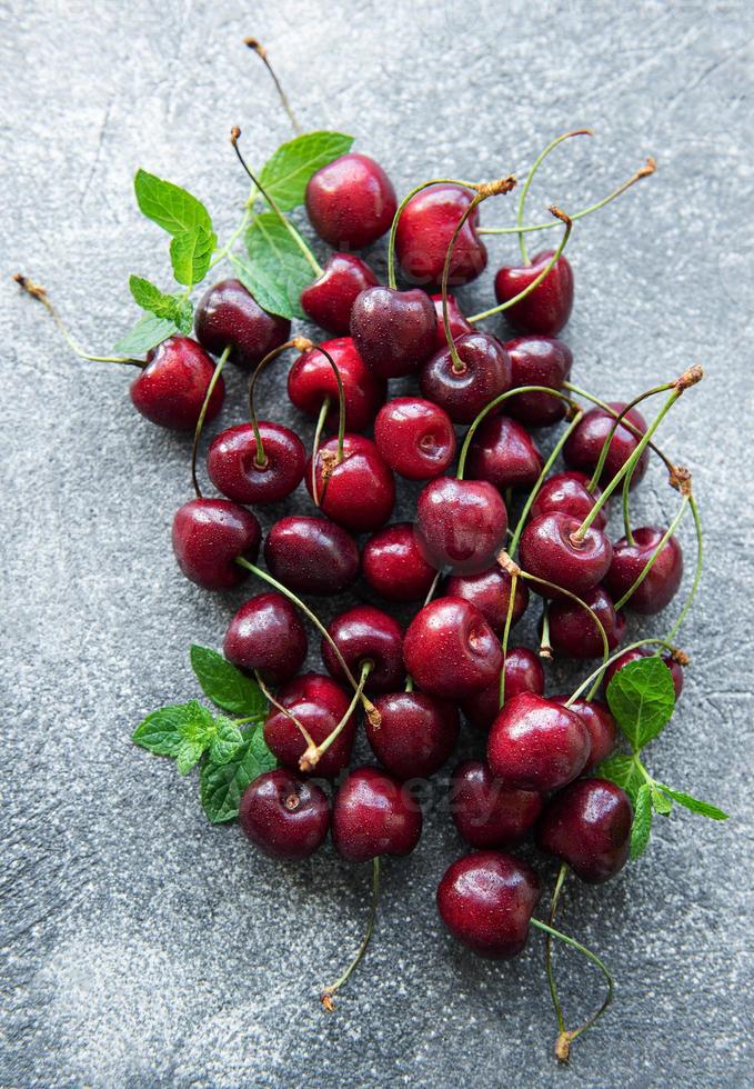 Fresh Cherry on concrete background photo