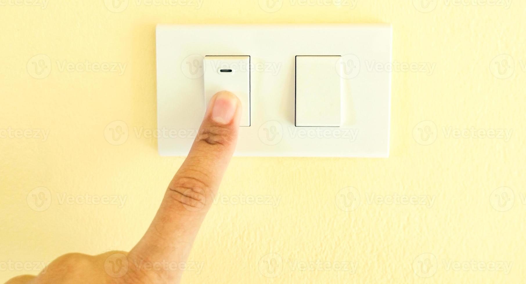 White light switch, finger press on off, the concept of saving electricity, reducing costs. photo