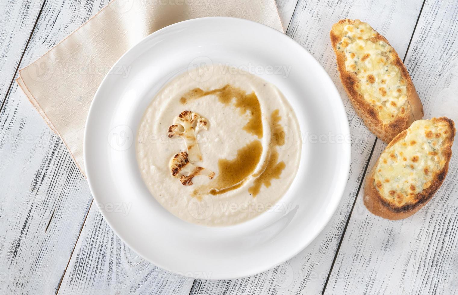 Cauliflower soup with bread photo