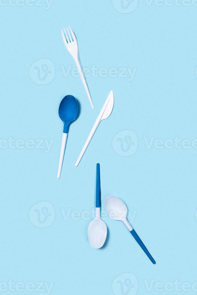 Picture of white spoons on blue background. photo