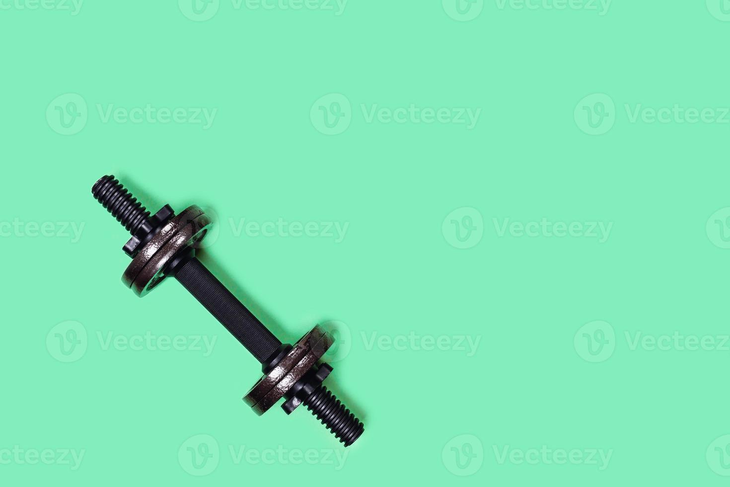 Dumbbell on color background. photo