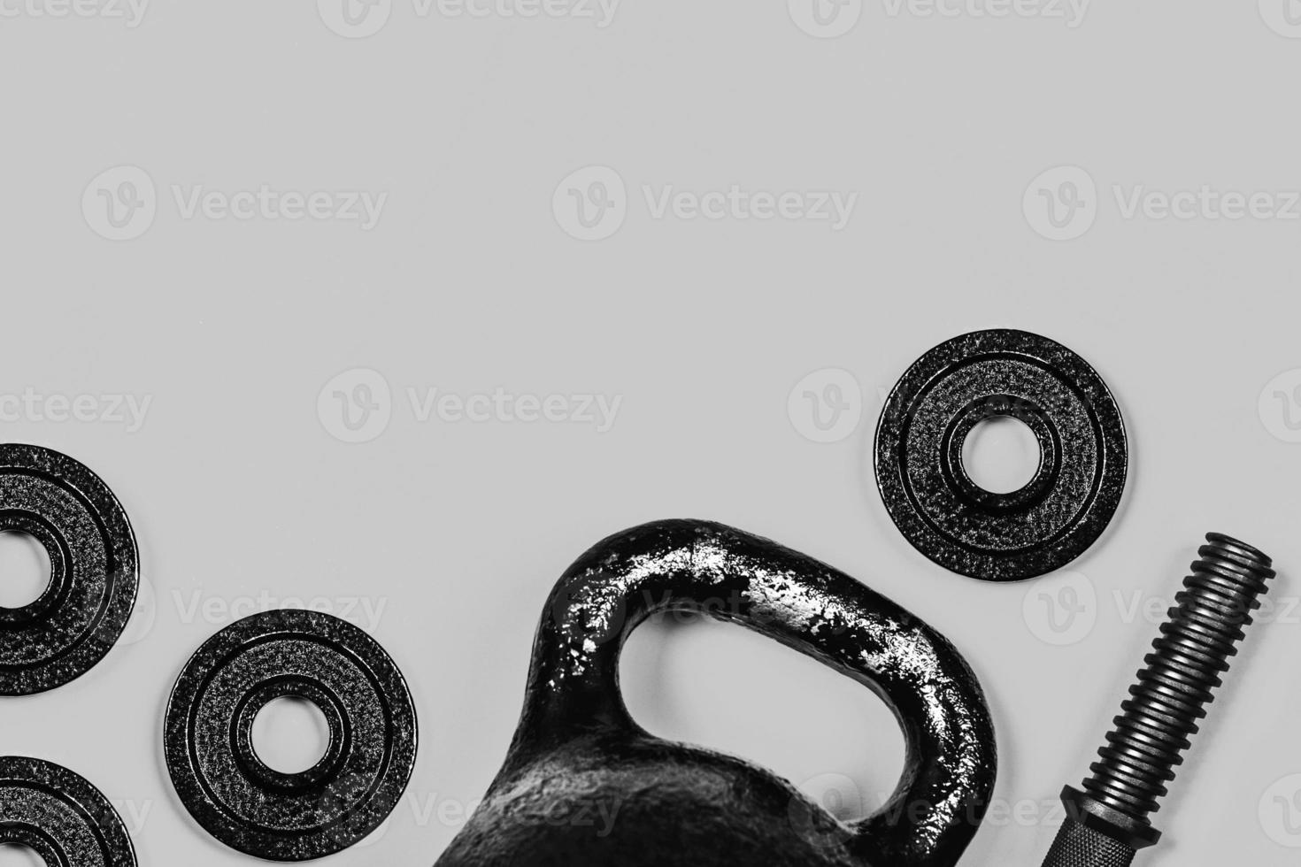 Kettlebell and dumbbell on grey background. photo
