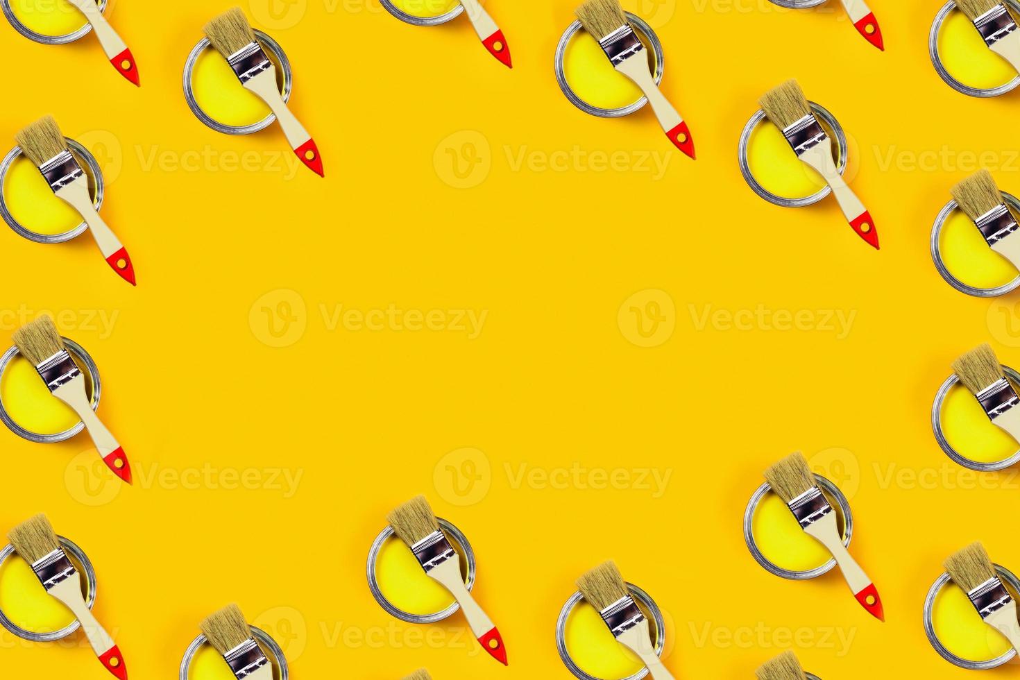 Colored background with paint jars and brushes. photo