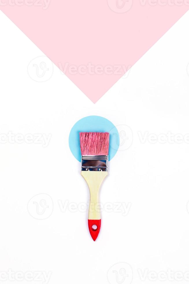 Two-toned background with one paint brush. photo