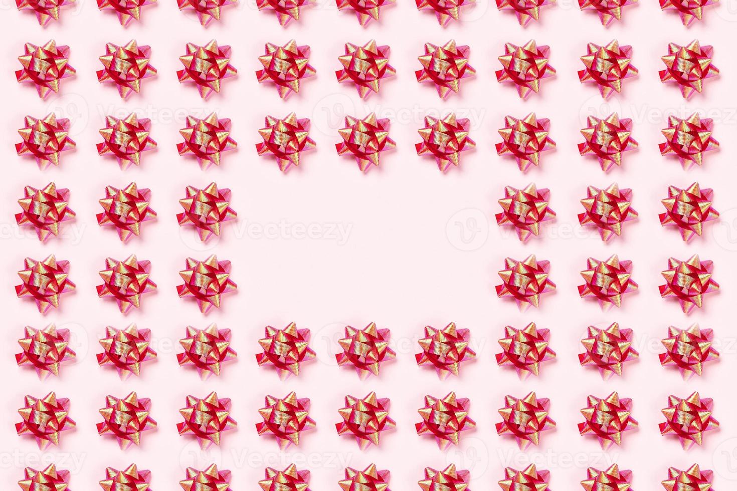 Christmas pink background with red bows. photo
