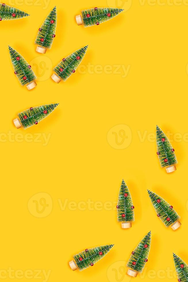 Yellow background with christmas trees. photo