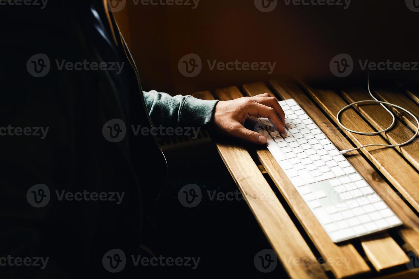 Men's hands on the keyboard. photo