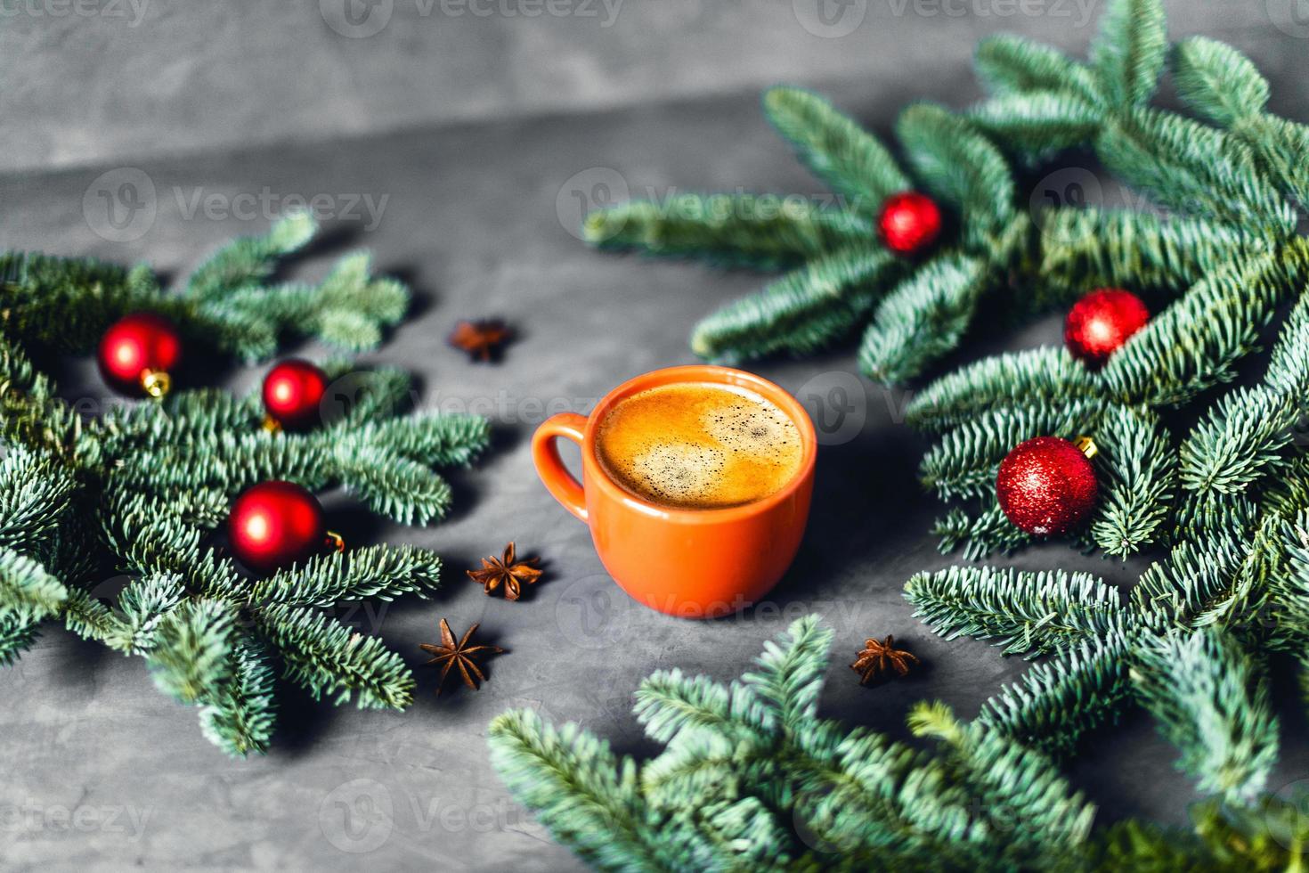 Delicious coffee on gray background with spruce branches. photo