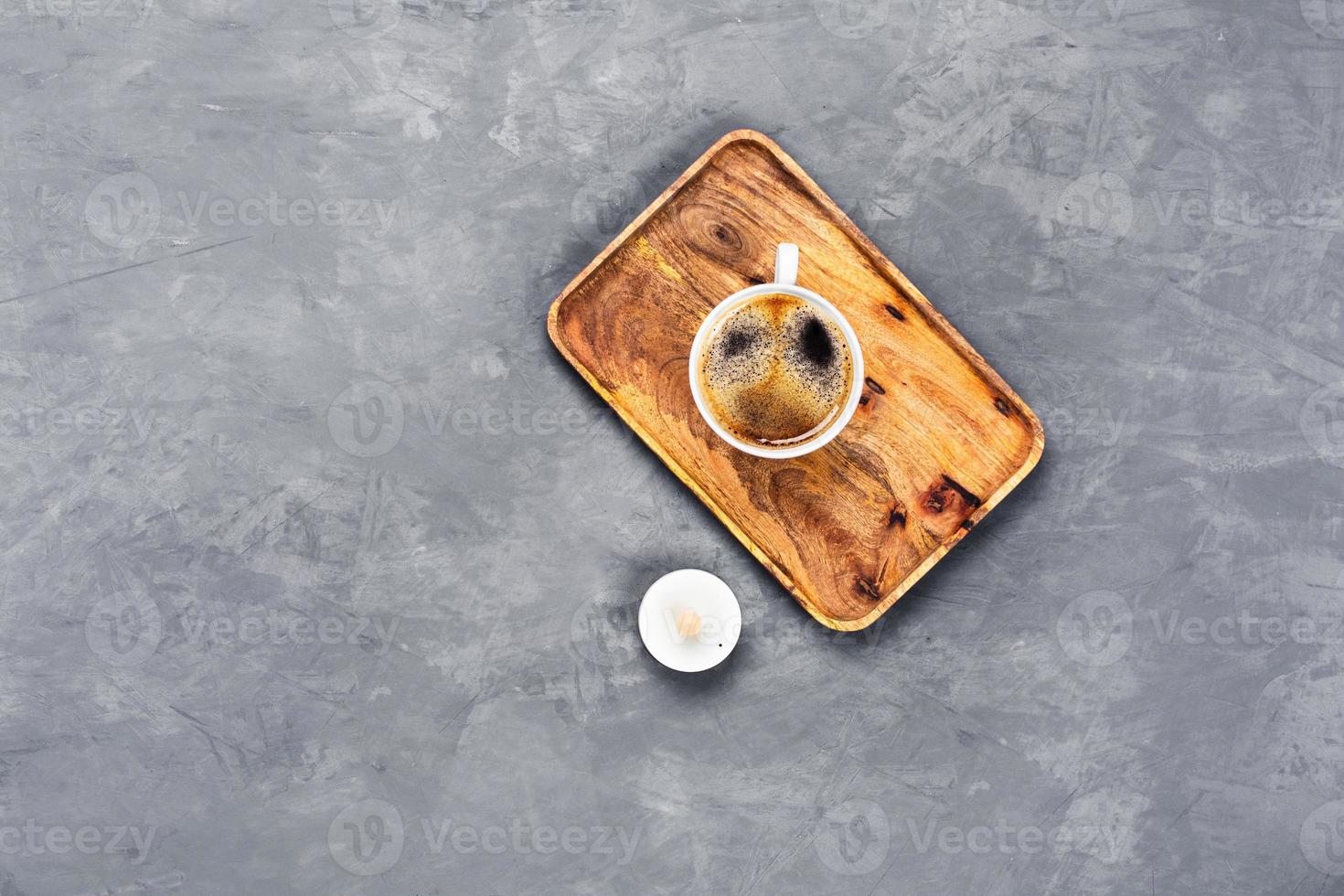 Gray background with cup of coffee and electric candle. photo