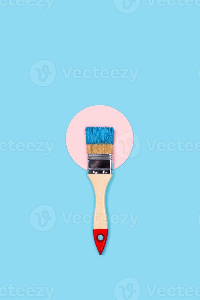 Blue background with paint brush and circle. photo