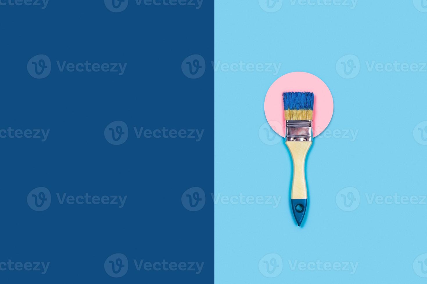 Two toned background with paint brush. photo