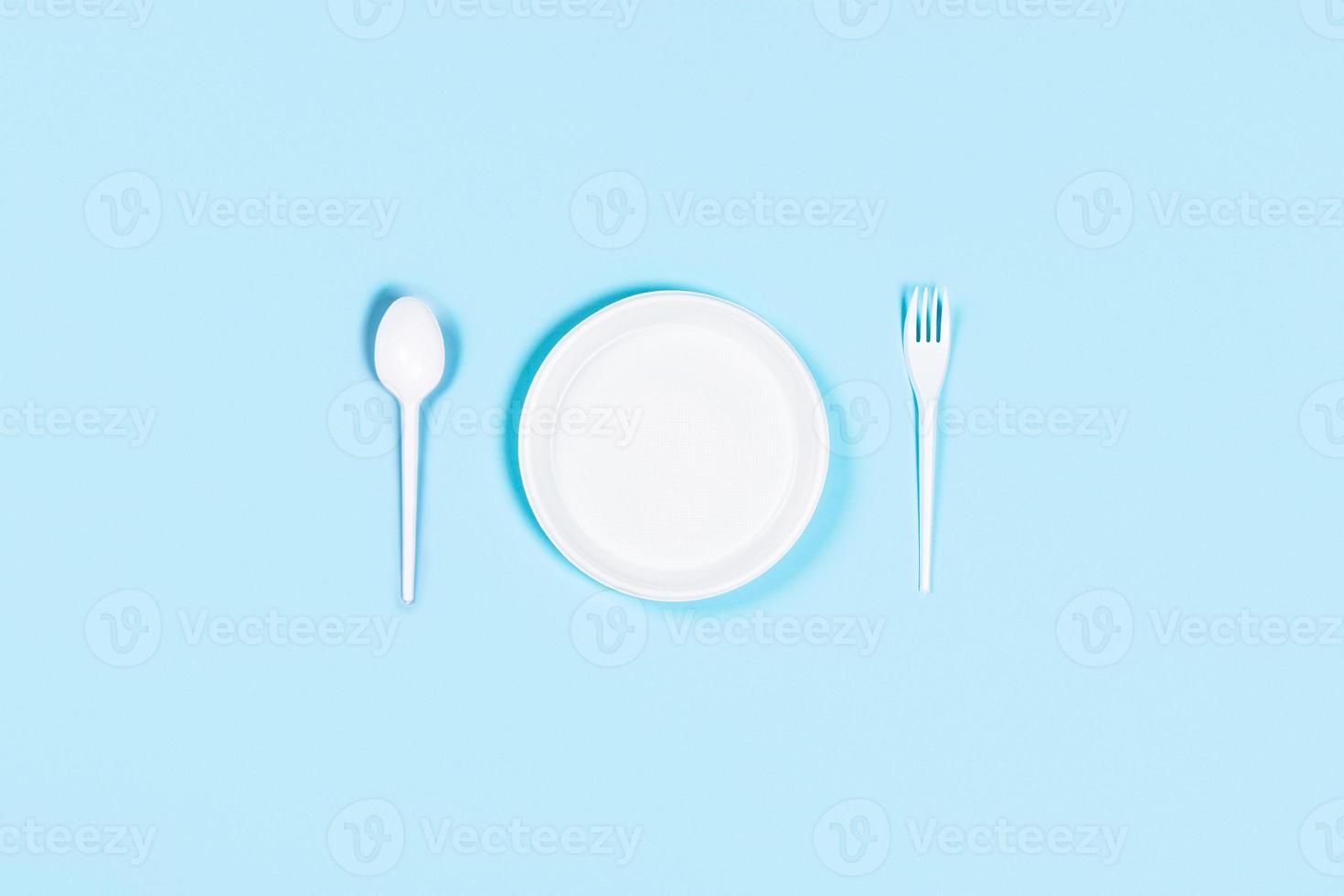 Blue background with plastic utensils. photo