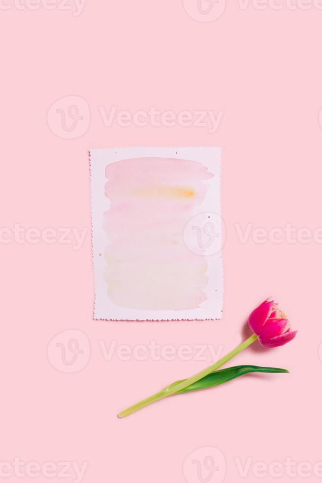 A greeting card on a pink background. photo