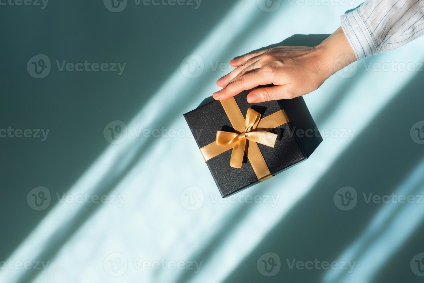 Hands with a gift box. photo