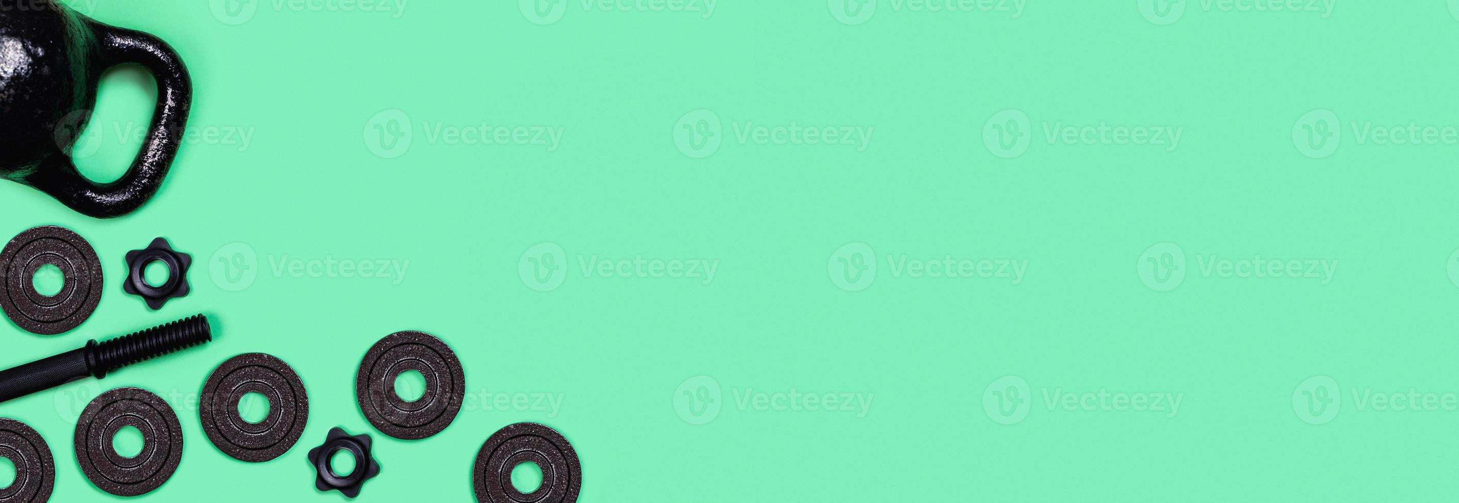 Kettlebells and dumbbells on color background. photo