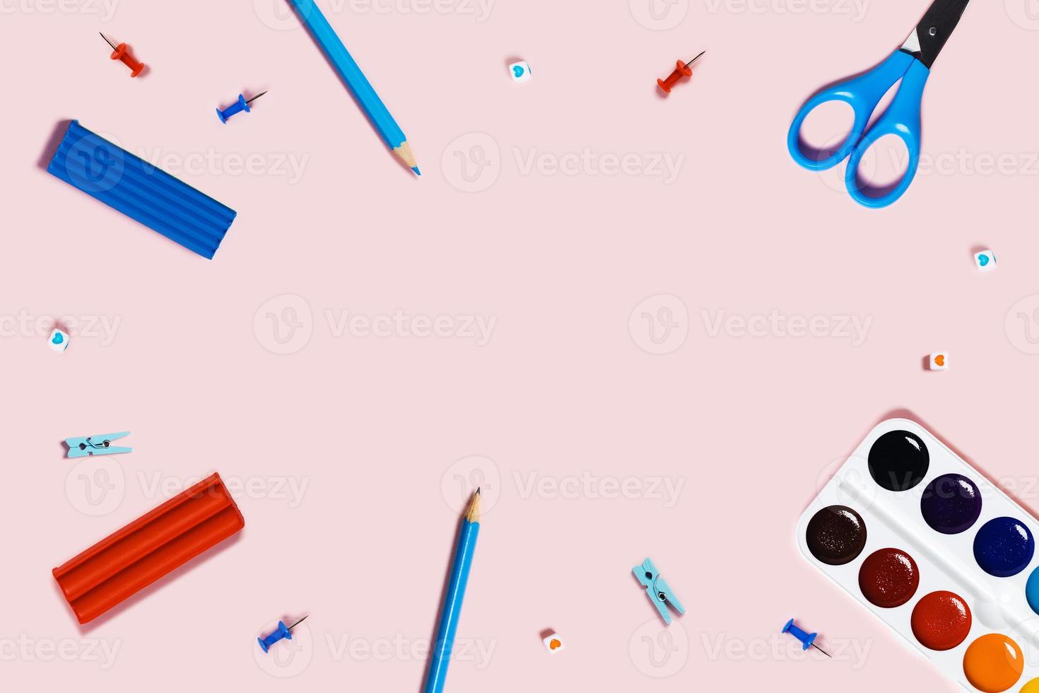 Pink background with writing materials. photo