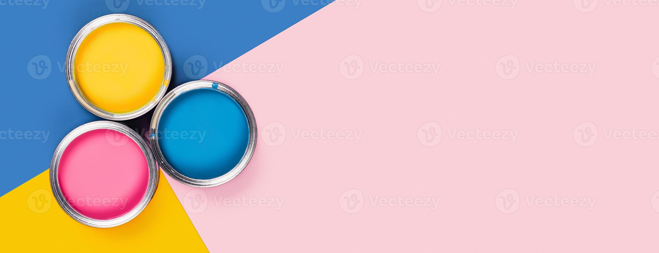 Three-colored background with paint jars. photo