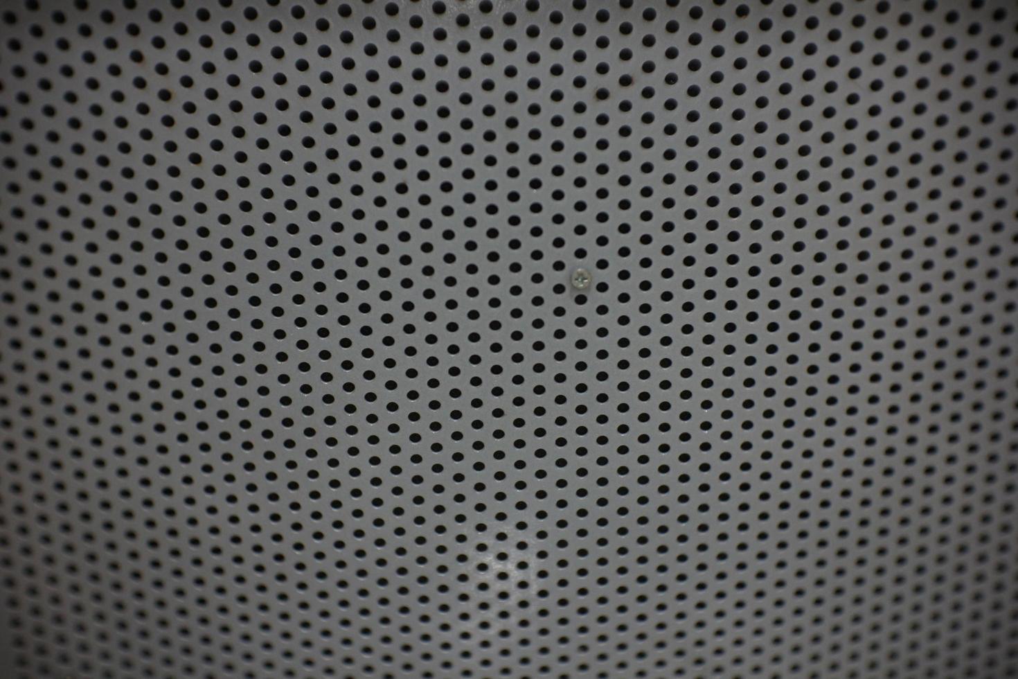 photo of a small hole in the back of an iron chair can be used as wallpaper or background.