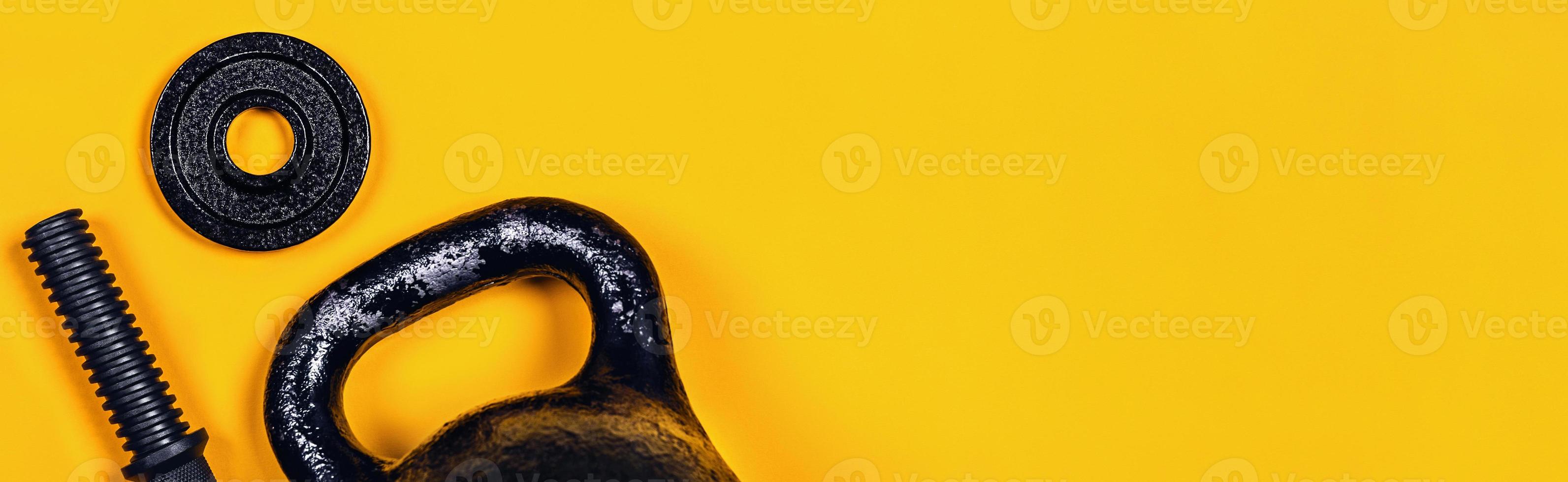 Kettlebell and dumbbell on color background. photo