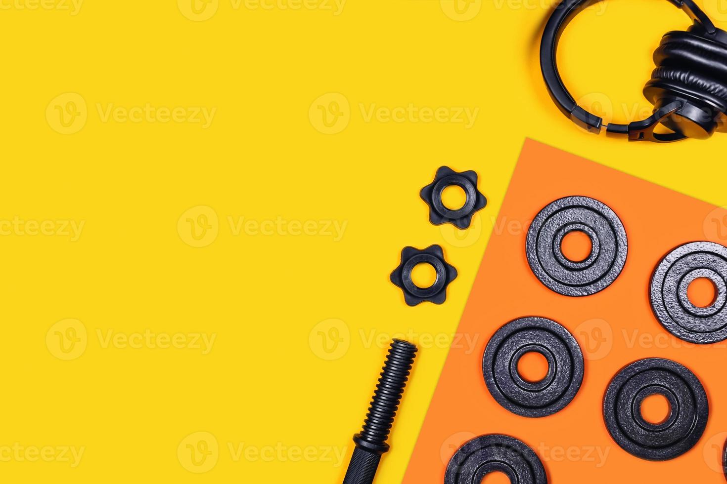 Kettlebell and headphones on color background. photo