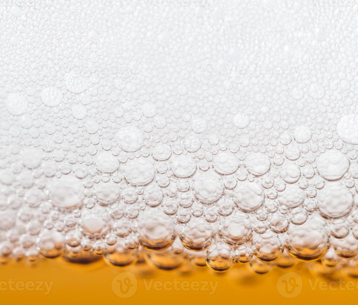 beer bubbles in a glass of fresh amber beer photo