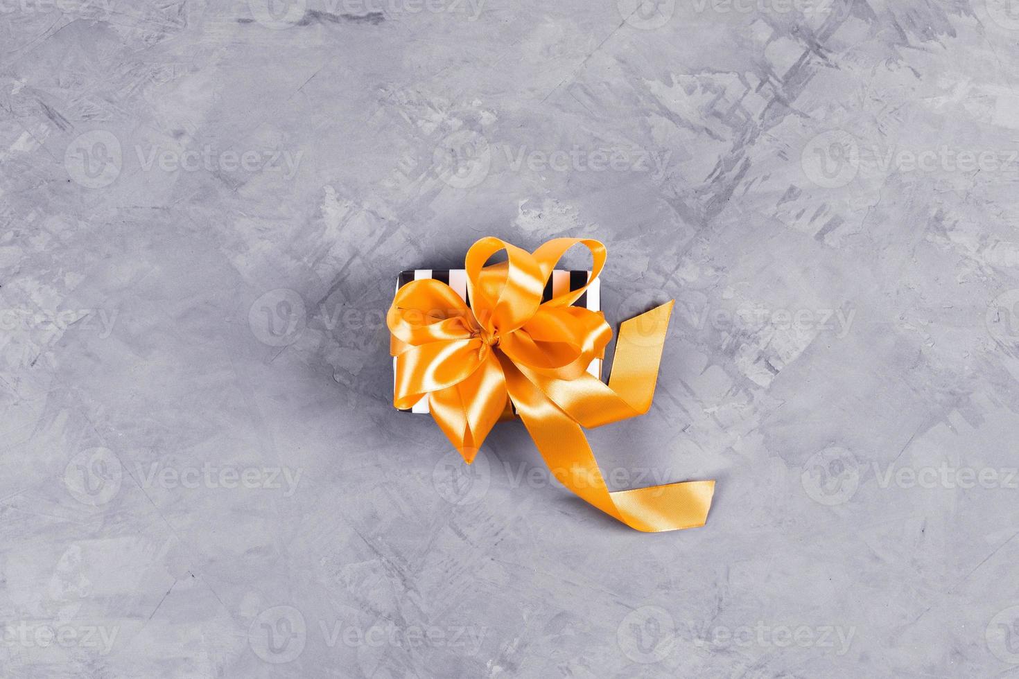 Present gift box on concrete background. photo