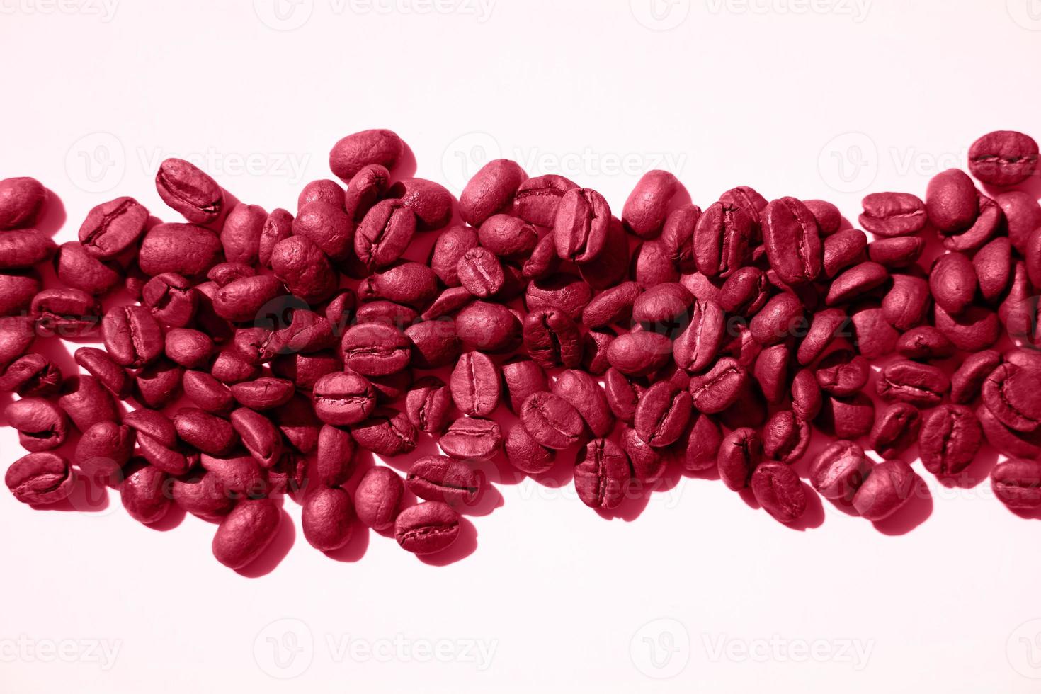 Isolated roasted magenta coffee beans in harsh light photo