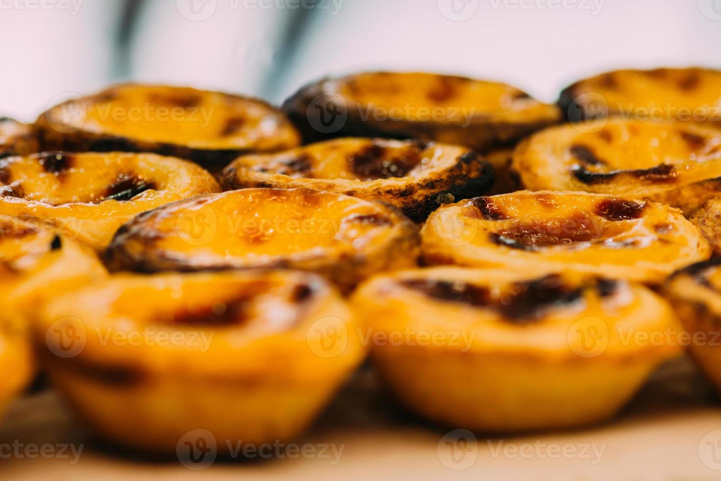 Stack of Portuguese egg tart also known as Pasteis de Nata on display in front of shop photo