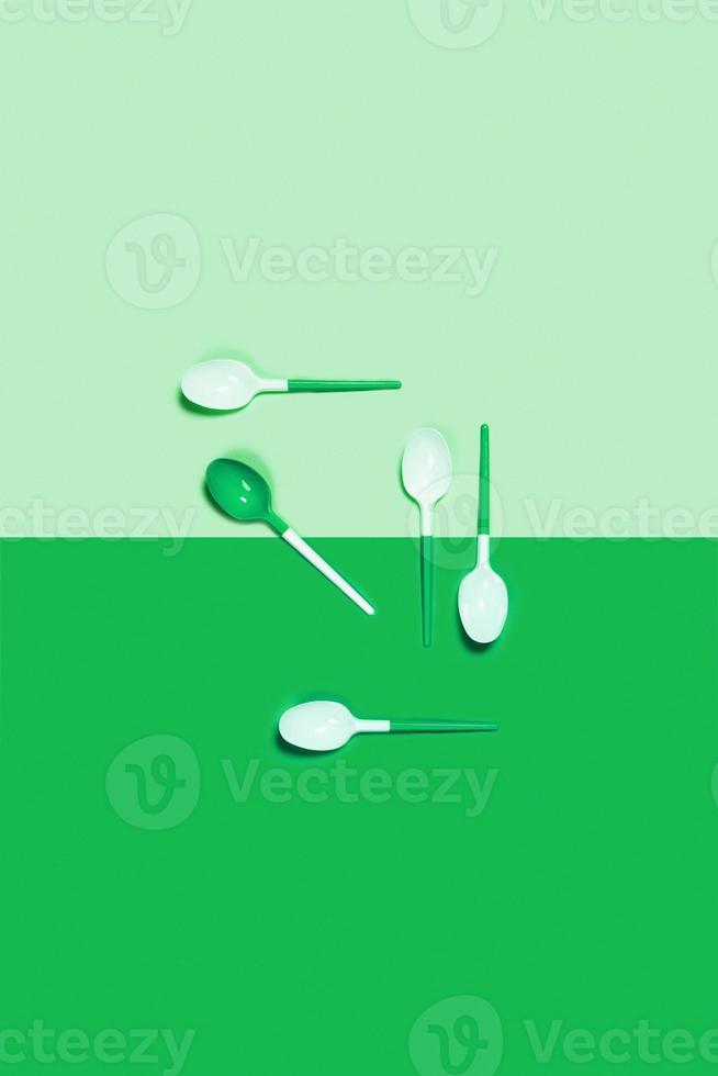 Picture of white spoons on color background. photo