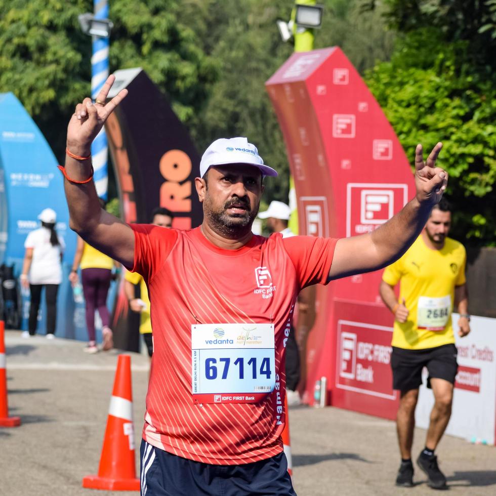 New Delhi, India - October 16 2022 - Vedanta Delhi Half Marathon race after covid in which marathon participants about to cross the finish line, Delhi Half Marathon 2022 photo