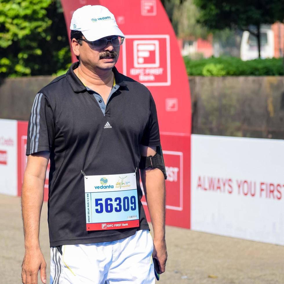 New Delhi, India - October 16 2022 - Vedanta Delhi Half Marathon race after covid in which marathon participants about to cross the finish line, Delhi Half Marathon 2022 photo