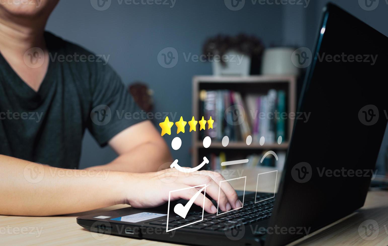 a businessman use computer laptop choose on the happy smile face icon to give satisfaction in service.rating very impressed.Customer service and Satisfaction concept photo