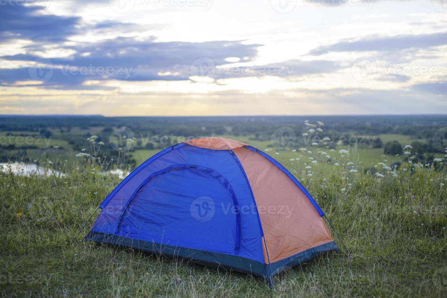 Tourist tent on mountain landscape at sunset in summer. Tourism Adventure travel lifestyle concept. photo