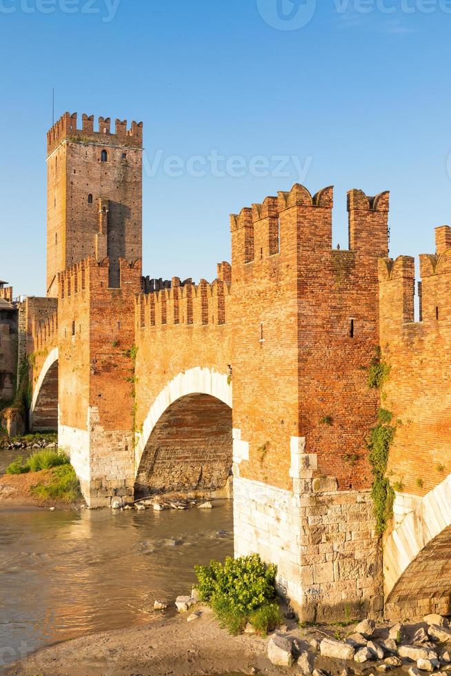 Verona, Italy. Castelvecchio bridge on Adige river. Old castle sightseeing at sunrise. photo