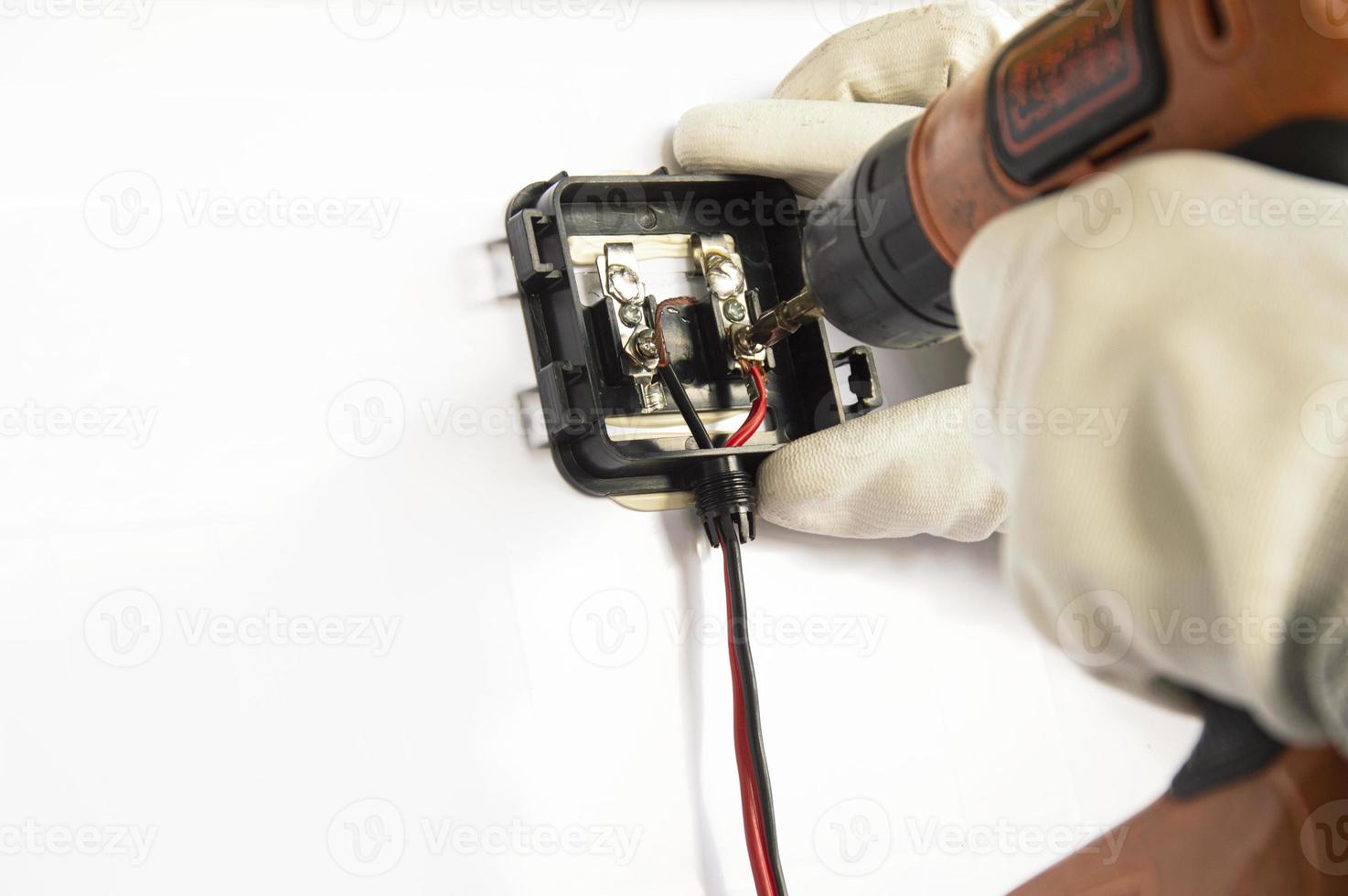 Technicians are connecting wires to solar panels. photo