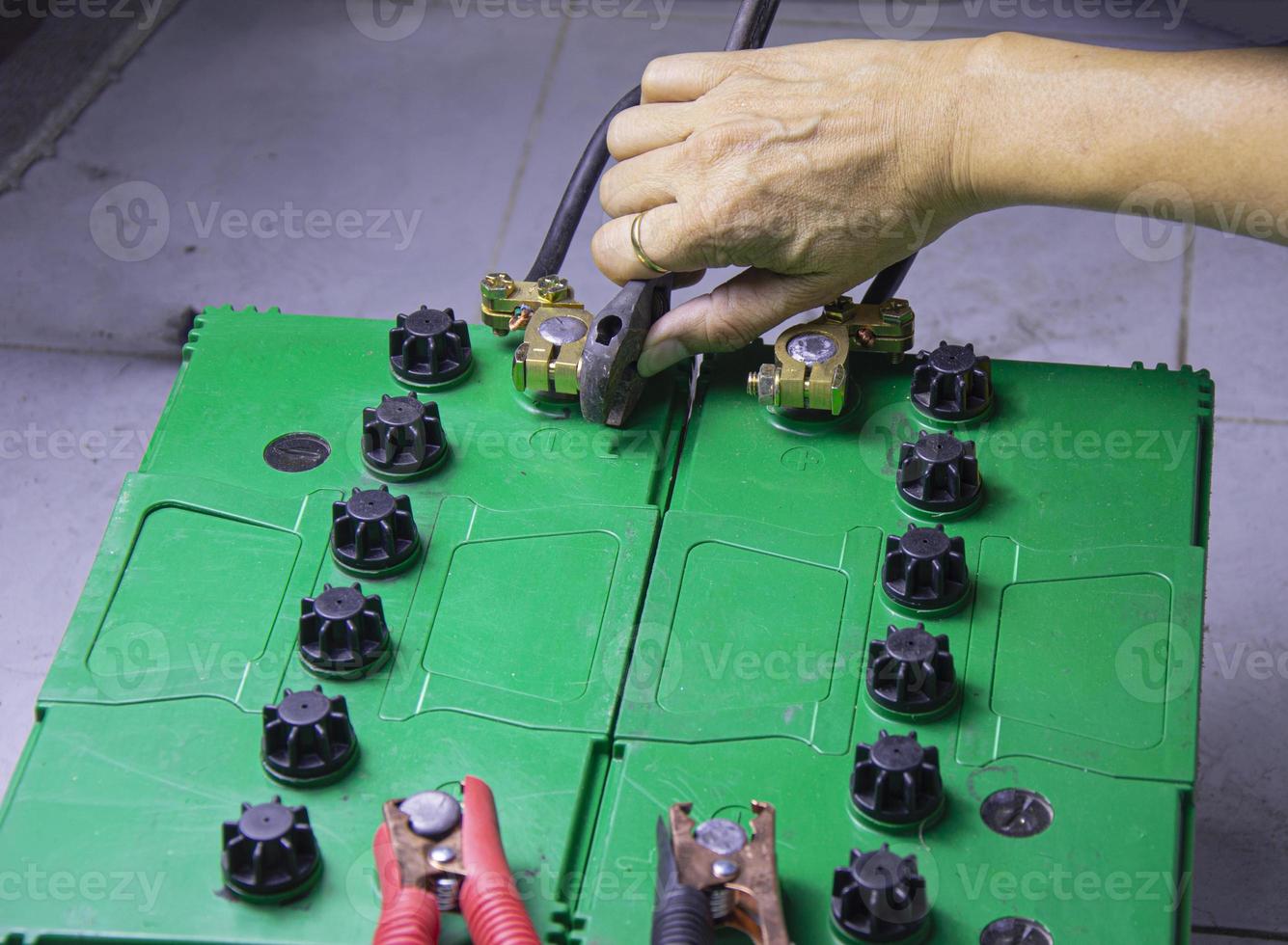 electrician connecting battery terminals 15589591 Stock Photo at Vecteezy
