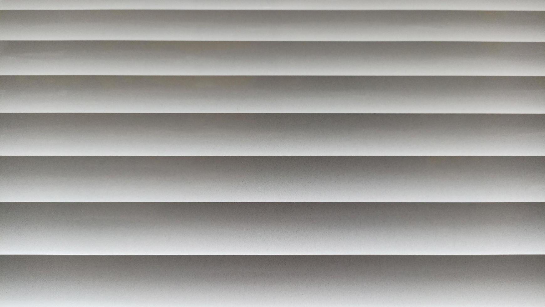 Window blinds with wavy gray striped background photo