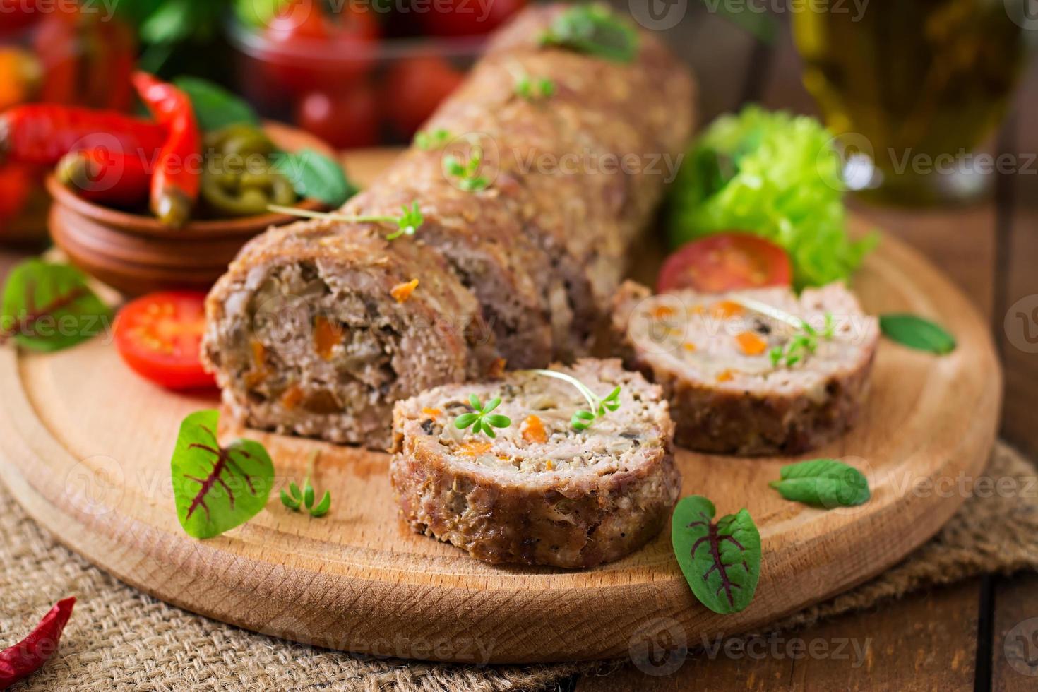 Minced meat loaf roll with mushrooms and carrots photo
