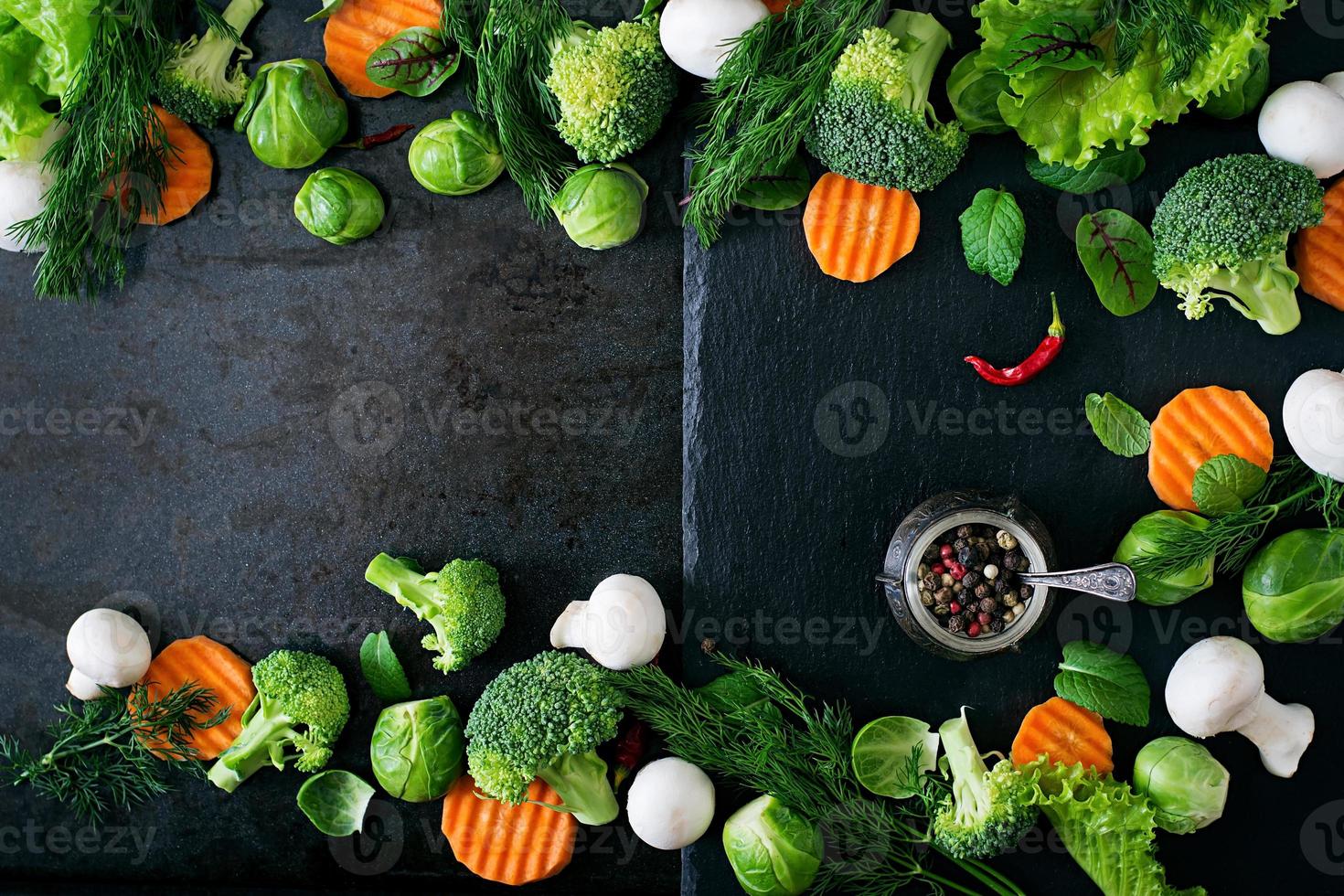 Fresh vegetables for a healthy diet on a dark background in a rustic style. Vegetarian food. Top view photo