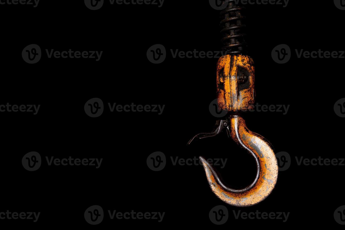 Crane hook. The system of pulleys and ropes. Close up crane hook for overhead crane. Isolated on black background. photo