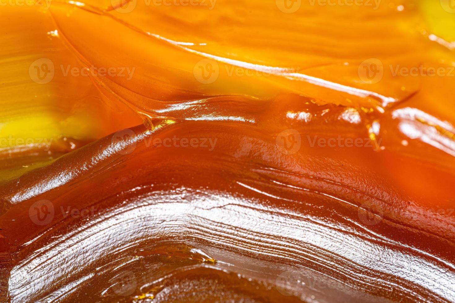 Close up of orange colored industrial grease. Rich and thick texture of industrial grade grease used to smooth out all metal friction. Lubricating grease. close-up of yellow lithium grease for machine photo