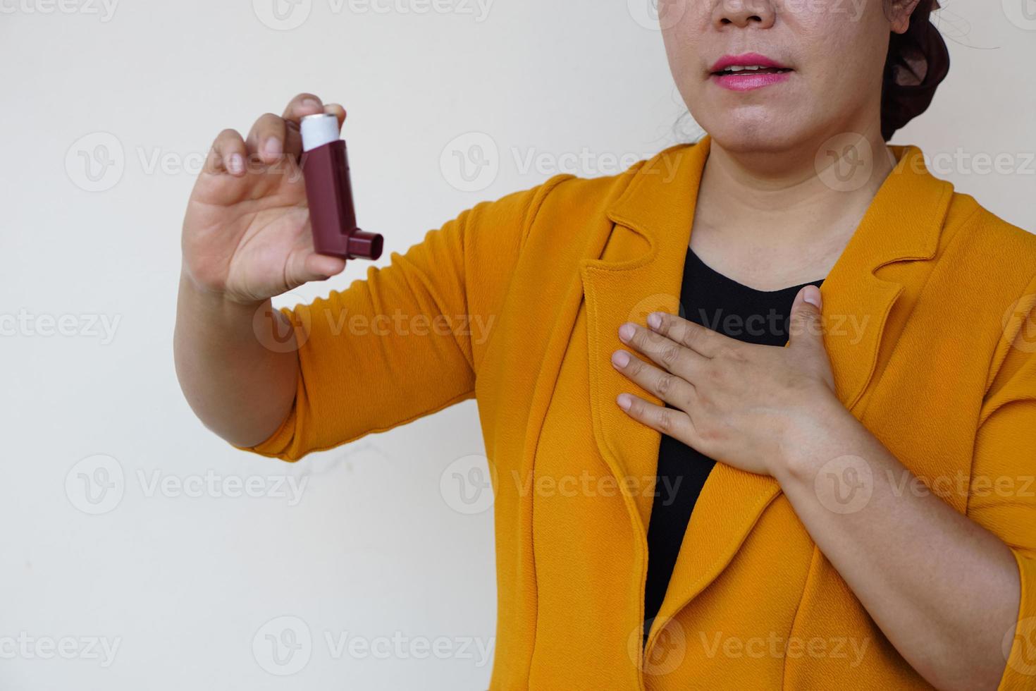 Closeup female patient uses brown asthma inhaler for relief asthma. Concept , Health care at home.  Pharmaceutical products for treatment symptoms of asthma or COPD. Use under prescription. photo