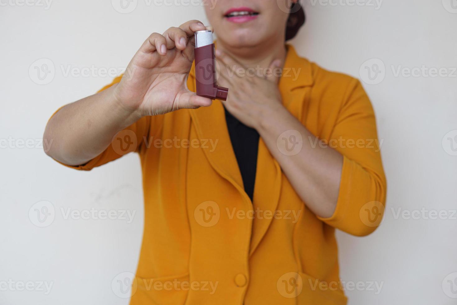 Closeup female patient uses brown asthma inhaler for relief asthma. Concept , Health care at home.  Pharmaceutical products for treatment symptoms of asthma or COPD. Use under prescription. photo