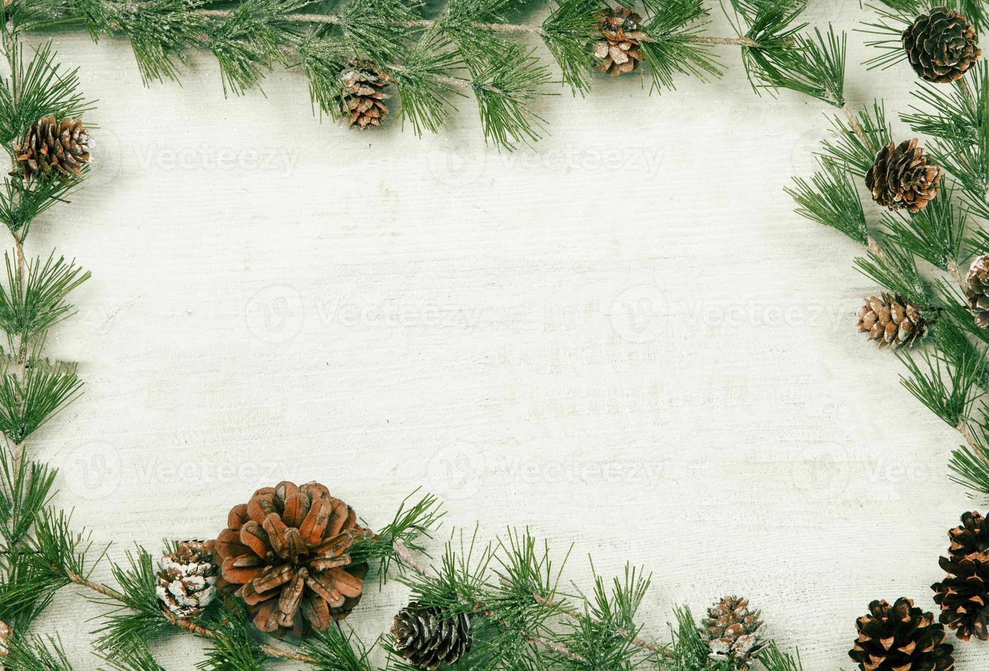 Christmas and New Year background with green spruce branches and pine cones, white banner, top view, copy space photo