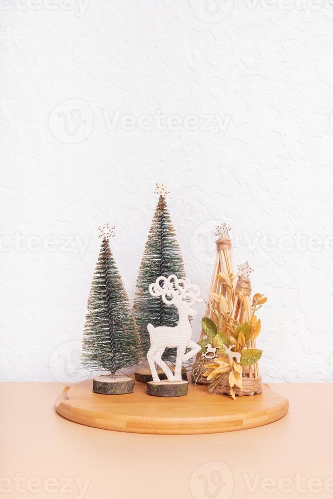 Christmas and New year still life composition in home interior. Xmas decorations with deer and Christmas trees photo