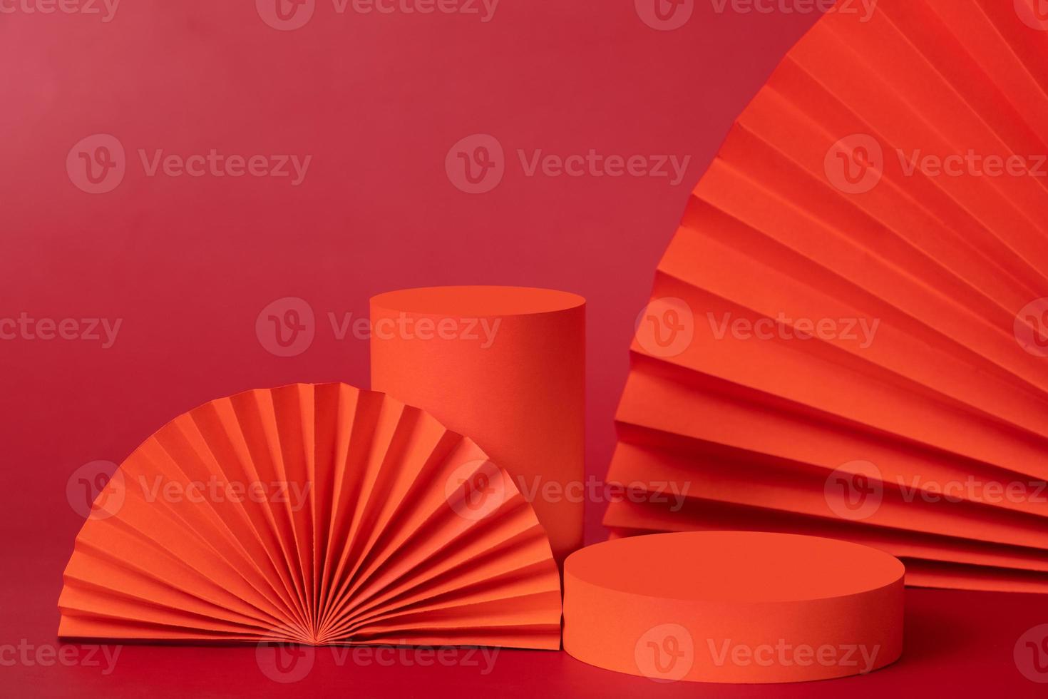Red podiums and fans still life composition for cosmetics products. New year Valetines day holidays decorations photo