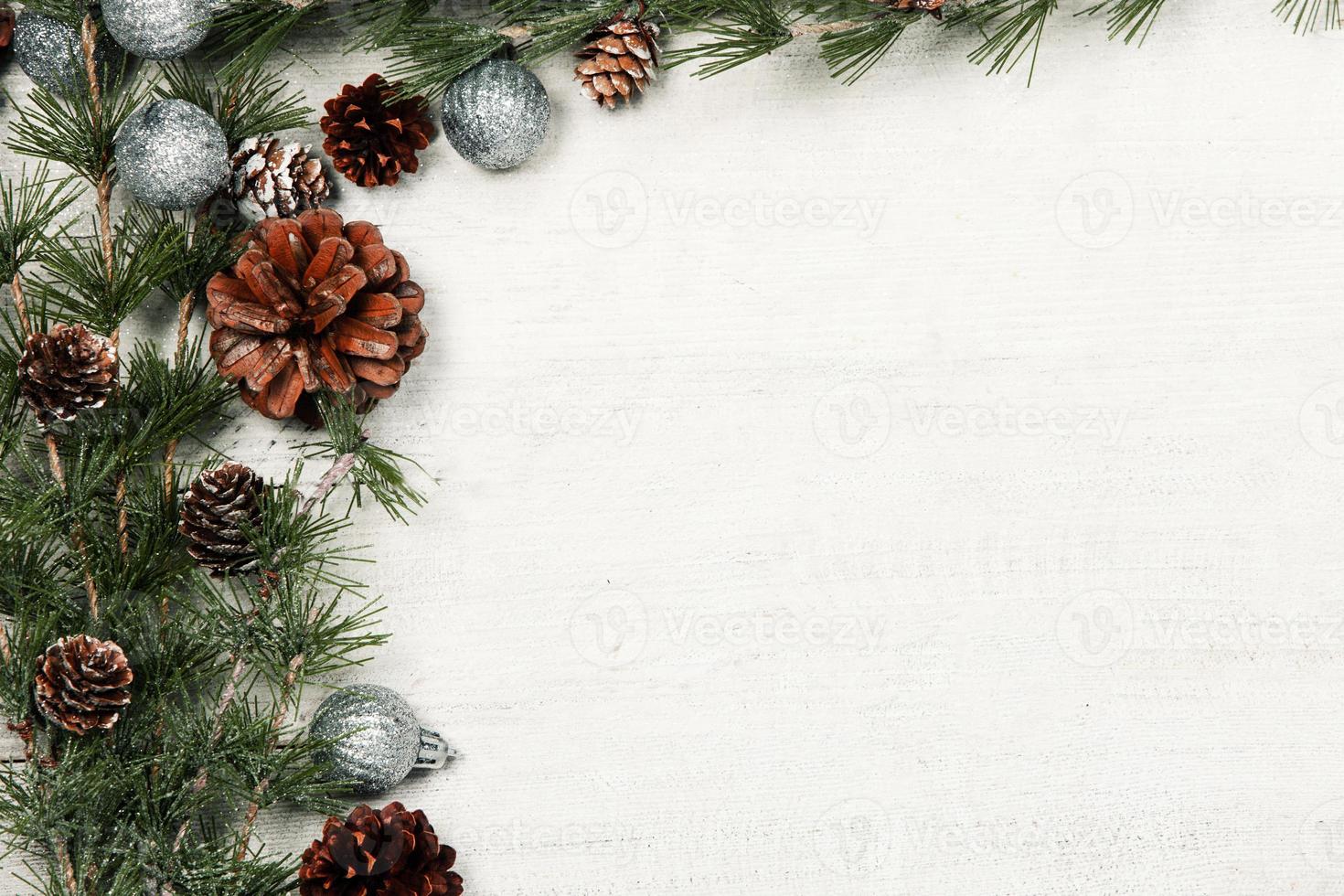 Christmas and New Year background with green spruce branches and pine cones, white banner, top view, copy space photo